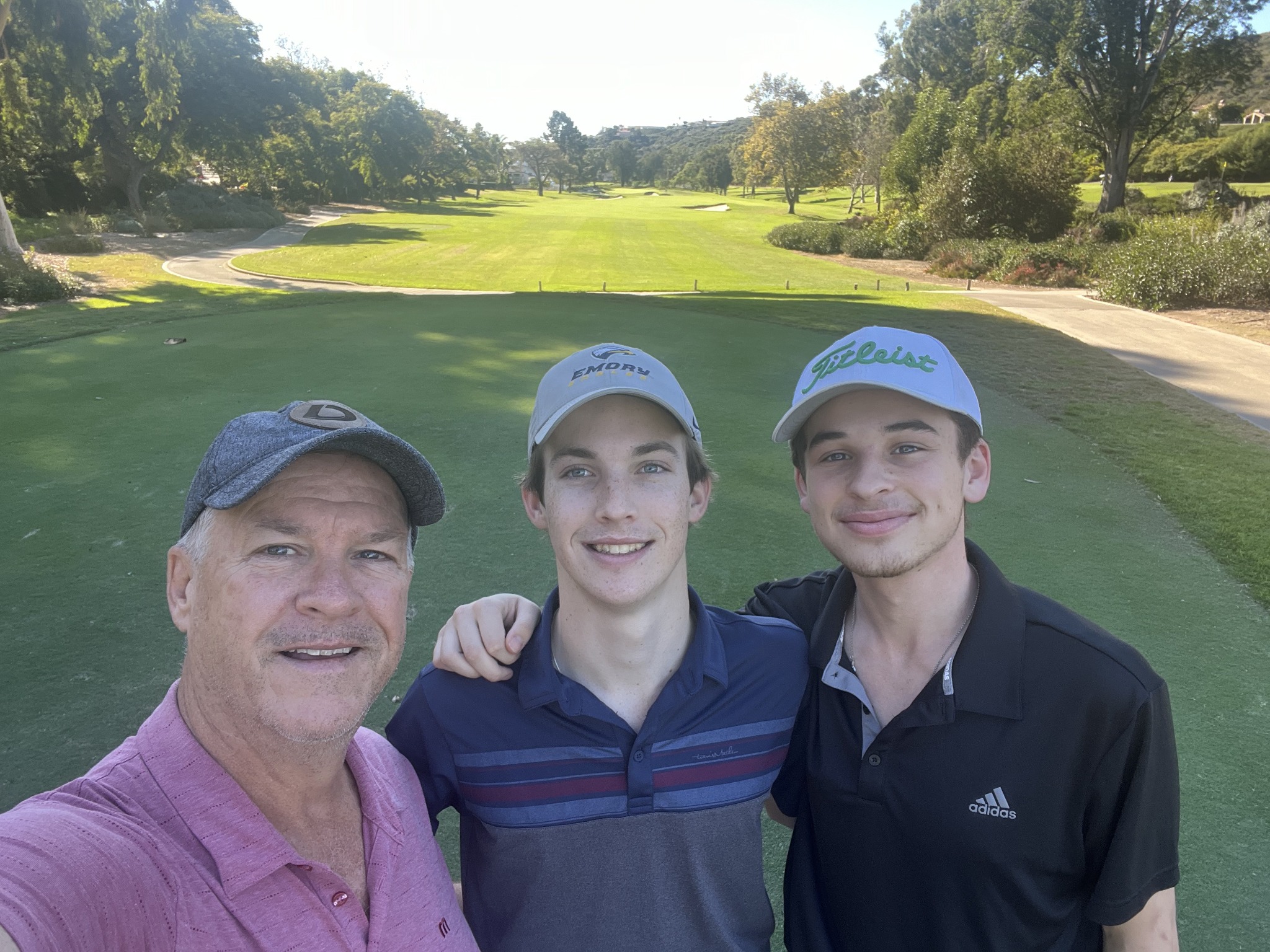 Three golfers together on the course